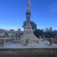 Statue of soldier standing to attention, names of the fallen listed below