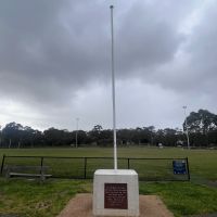 The flagpole and plinth stands next to the oval, facing the Rob C Browne Pavilion
